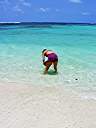 Nancy with a conch shell at Nancy and Walker's secret beach on Anegada