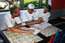 Coach Mike Morphew watches chefs Davide Pugliese and Scott Weston confer over the Mise en Place blind basket ingredient list.