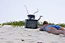 Television, Anegada style.
Nancy found this television on the beach on Anegada's north shore. We dressed it up a bit, making the "rabbit ear" antenna from an oil bottle, some sand and sticks. A nice little coral nick-nack on top, and we are ready to watch television. It turns out that our reflection is the only thing that we can receive on it.