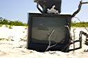 Television, Anegada style.
Nancy found this television on the beach on Anegada's north shore. We dressed it up a bit, making the "rabbit ear" antenna from an oil bottle, some sand and sticks. A nice little coral nick-nack on top, and we are ready to watch television. It turns out that our reflection is the only thing that we can receive on it.