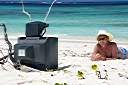 Television, Anegada style.
Nancy found this television on the beach on Anegada's north shore. We dressed it up a bit, making the "rabbit ear" antenna from an oil bottle, some sand and sticks. A nice little coral nick-nack on top, and we are ready to watch television. It turns out that our reflection is the only thing that we can receive on it.