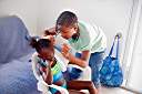 Lakesha braiding Ebony's hair at Hidden Treasure.