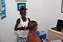 Janesha braiding Nancy's hair.