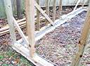 Pavers have been leveled and concrete foundation beam poured inside them and under wooden foundation beam.