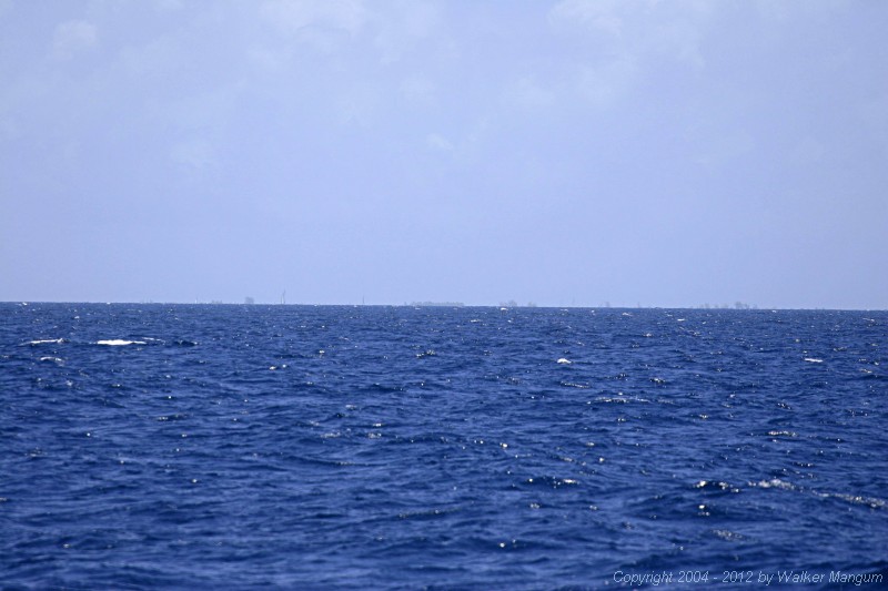 Anegada on the horizon. This photo was taken with a long telephoto lens from seven miles out. It is what you would see with a good pair of binoculars.