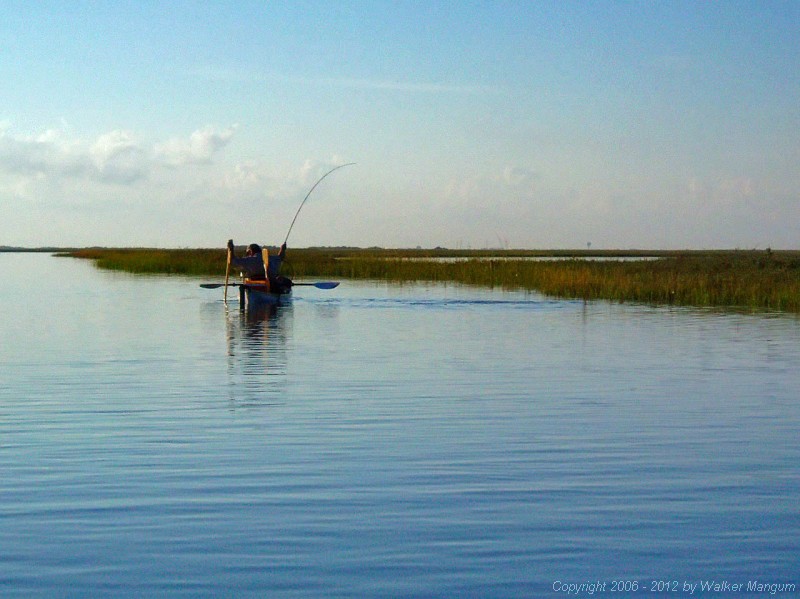 Planting the pole to keep the fish from pulling me into the grass.