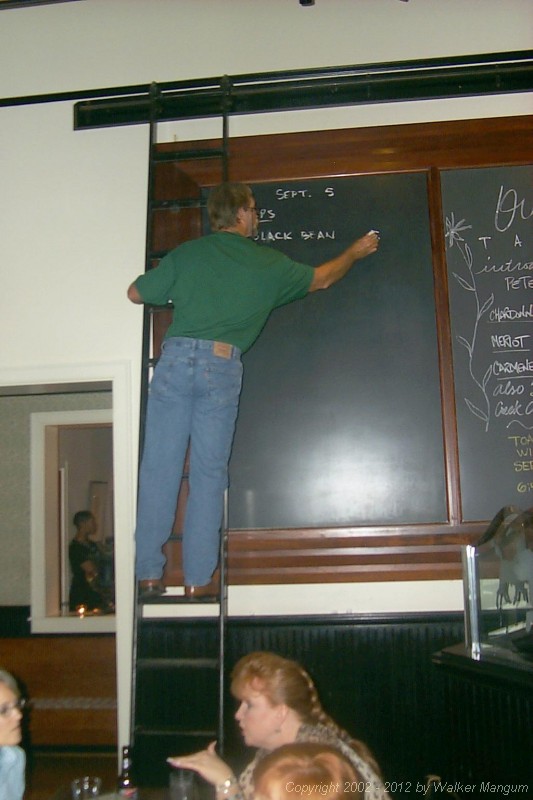 Walker writes the blackboard menu at Ouisie's.