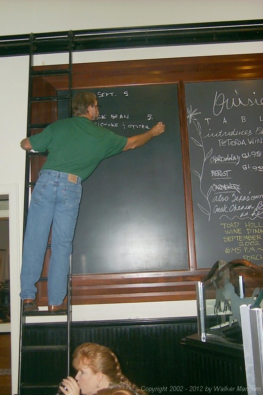 Walker writes the blackboard menu at Ouisie's.