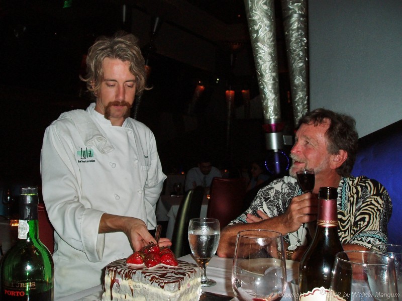 Zula's executive chef Jason Kerr serves the birthday cake that he made for Walker.